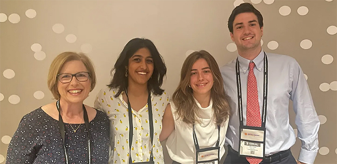 Professor Jill Wilson, left, poses with Sahaana Rajesh, Emilia McDougal, and Juan Olivia.