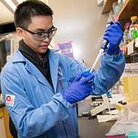 Scientist using a syringe