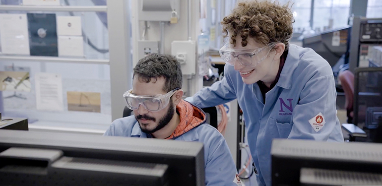 Two students in a lab engaged in a project.