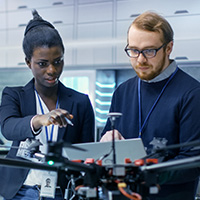 Two students working with a drone.