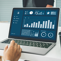 A laptop with bar graphs and pie charts