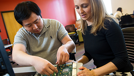 Two students working on a computer