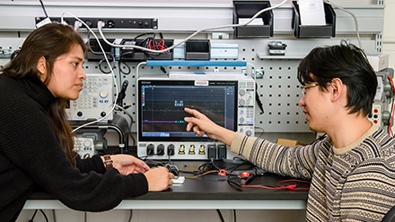 Two students working with a computer