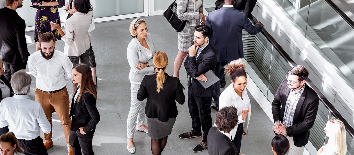 Business professionals networking in the lobby of a modern building