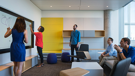 MBAi students working on a whiteboard