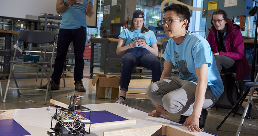 Student teams participate in the annual Design Competition by building semi-autonomous robots to compete in a round-robin style tournament based on the classic board game, Battleship.