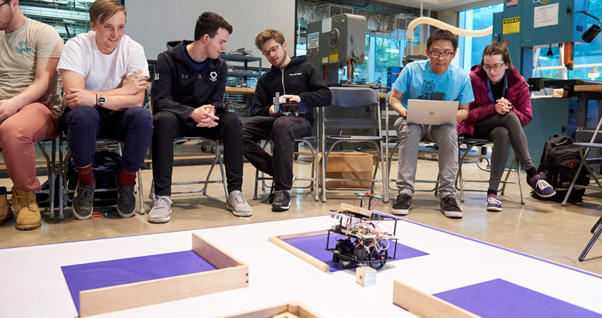 Students follow the robots in a game of "Battleship."