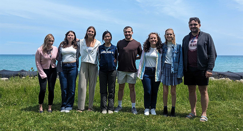 Shuyue Qu poses with members of Professor Daniel Horton’s lab team.