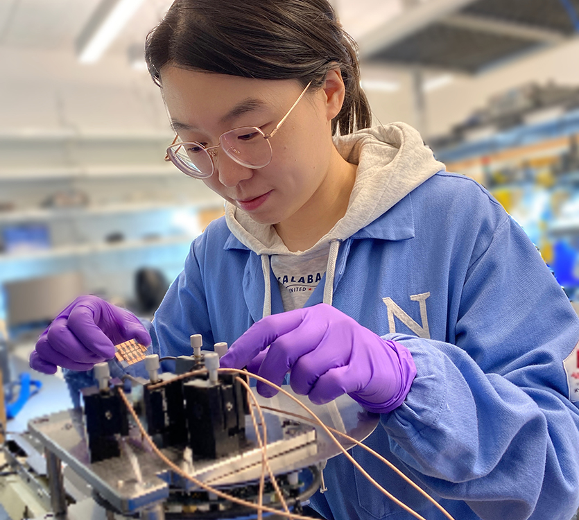 Yi Yang, the study's first author, tests a sample of the new solar cell in the lab.