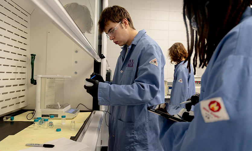 Undergraduates Wen-Yam ZONGO and Ben Sheward prepare electrode slurries for Li-ion battery fabrication. | Heather Eidson