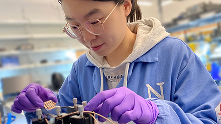 Yi Yang, the study's first author, tests a sample of the new solar cell in the lab.