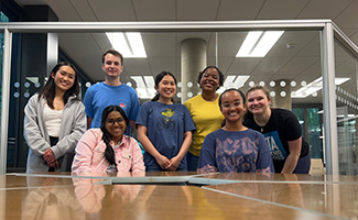 Group of 7 students smiling at camera