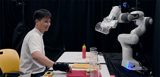 Felix Wang controlling a robot arm